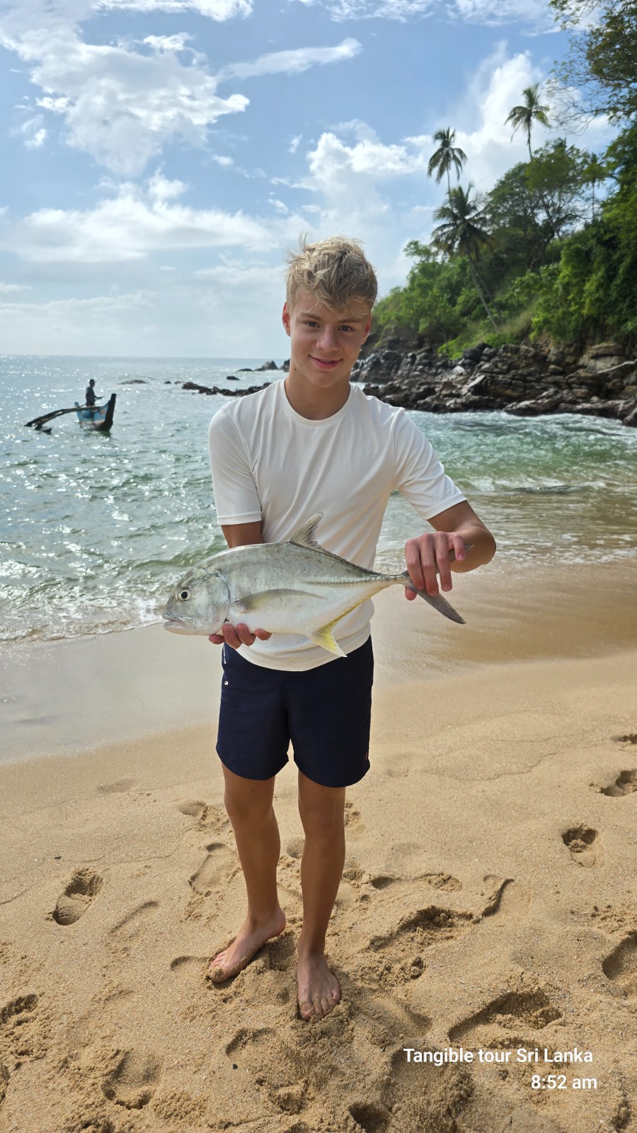 Guest holding a trevally caught on a Tangalle fishing trip